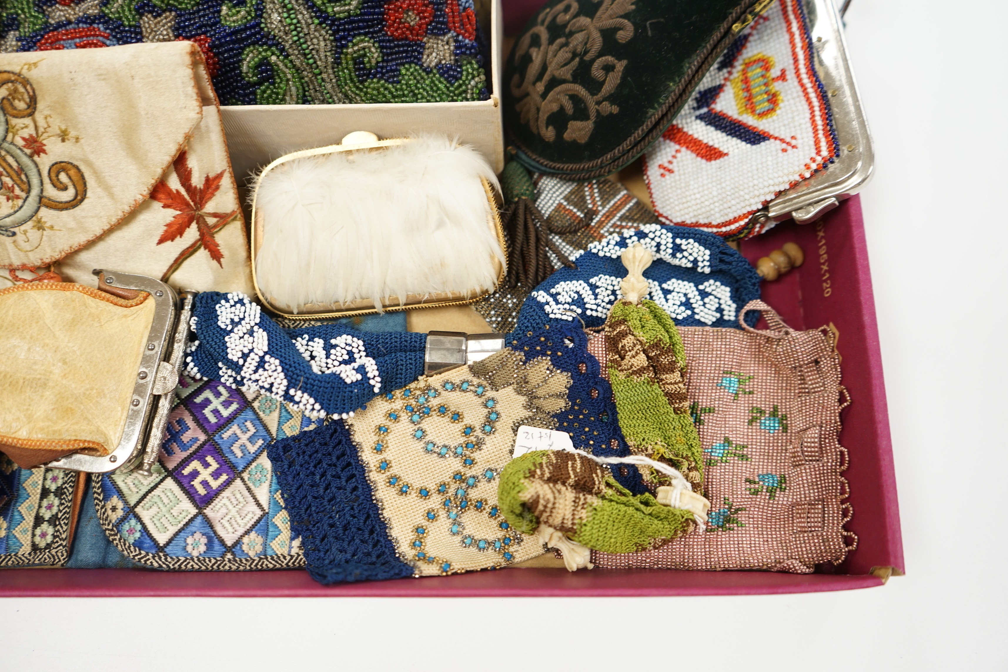 A velvet and metal embroidered reticule possibly 18th century, together with a collection of beaded embroidered knitted and leather purses, bags misers purses and a feather coin purse(14)